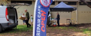 Image the repair cafe flag outside the building